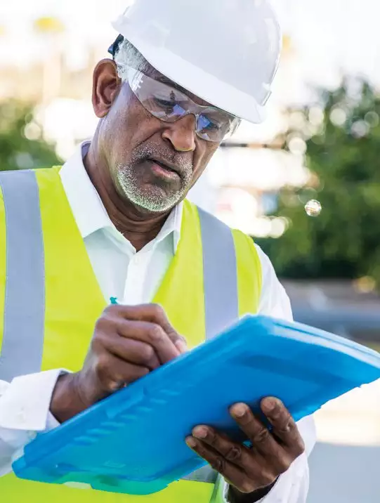 Construction Worker Writing in His Pad/Tablet