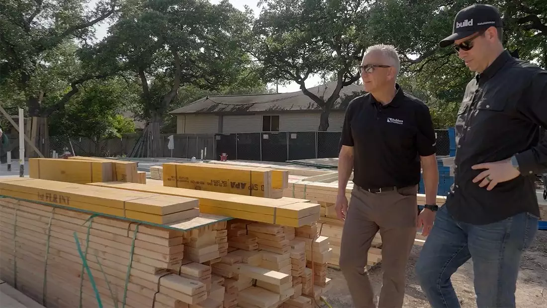 Matt and Guest Inspecting Stacked Lumber Placed on Austin Build Jobsite