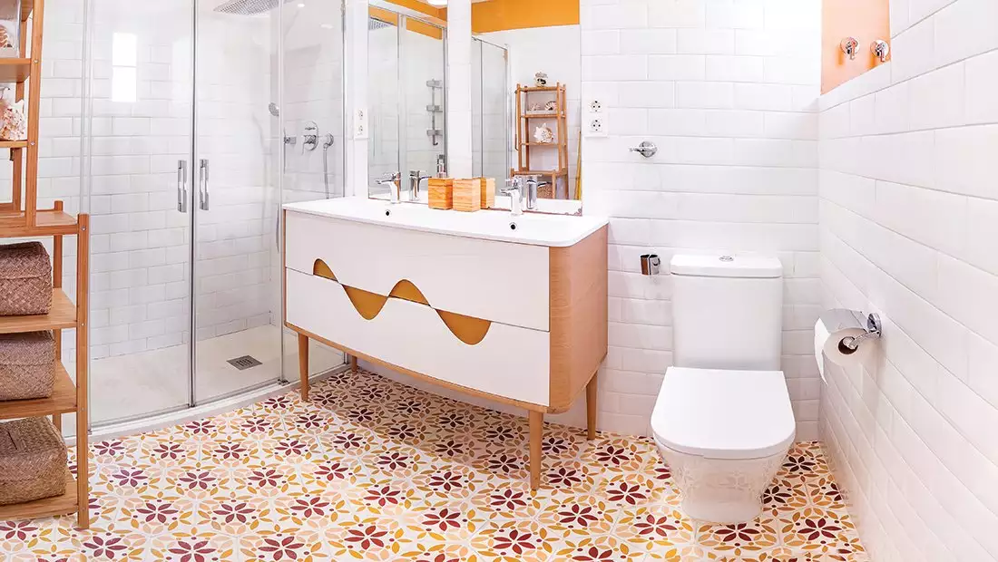 Retro bathroom with custom tiling and curved cabinet design