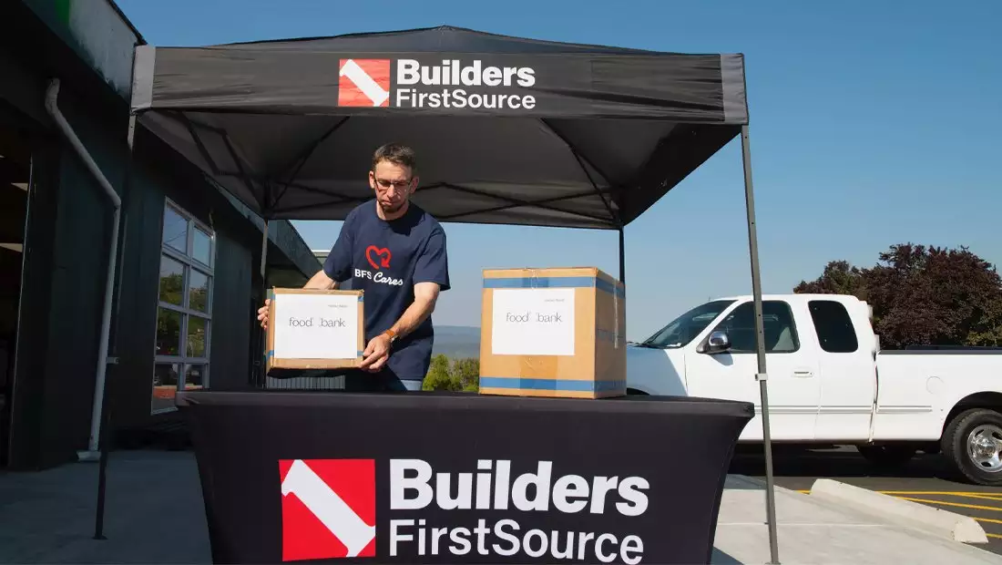 BFS volunteer placing food bank boxes on a table
